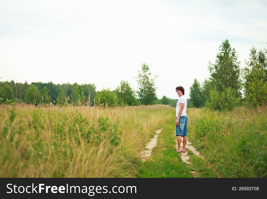 A Man Standing On A Country Road