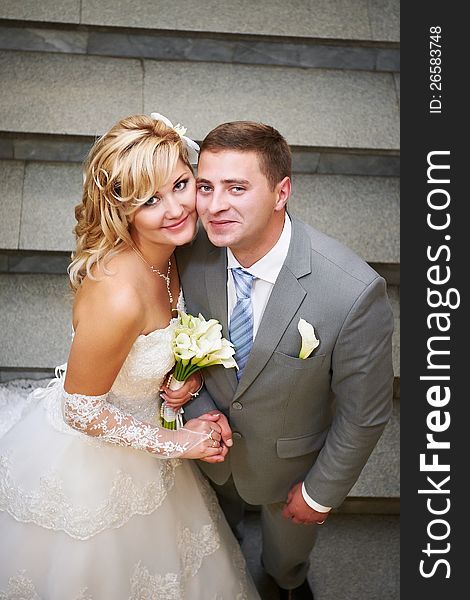 Happy Bride And Groom On The Stairs