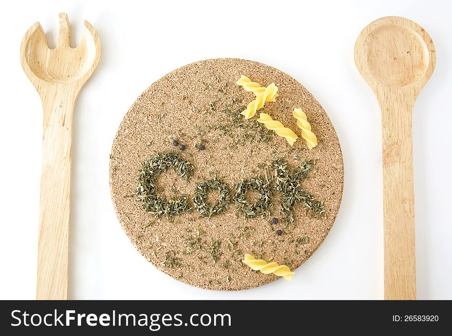 Wooden fork and spoon on meal set with wording Cook