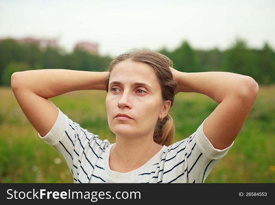 A young man sitting among flowering meadows. A young man sitting among flowering meadows.