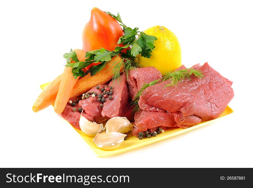 Vegetables with some spices and raw meat , on a white background. Vegetables with some spices and raw meat , on a white background