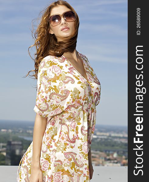 Beautiful girl in sunglasses on blue sky