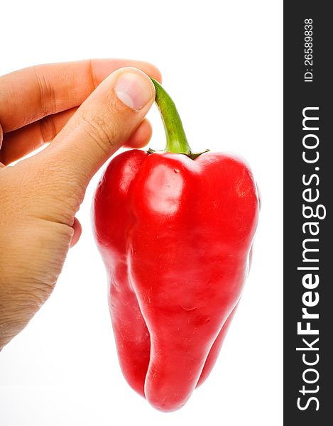 Hand with big red pepper isolated on white background