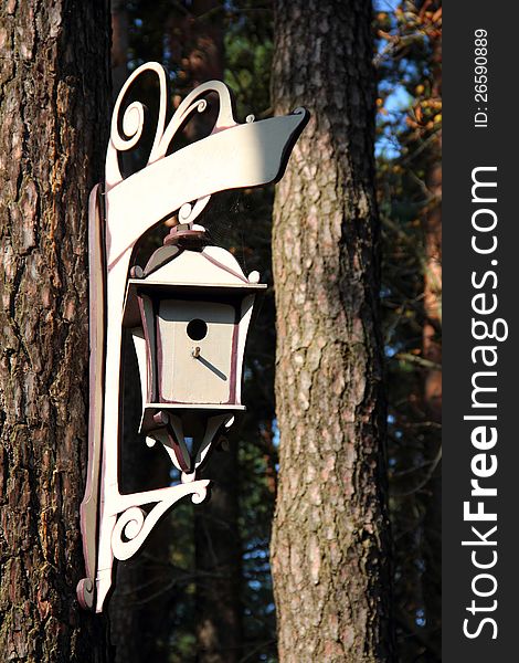 Graceful homemade birdhouse hanging from a tree. Graceful homemade birdhouse hanging from a tree