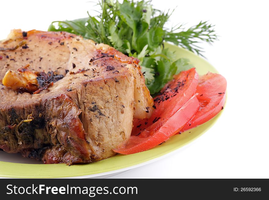 Juicy Pork Chop with Tomatoes and Dill on plate on white background