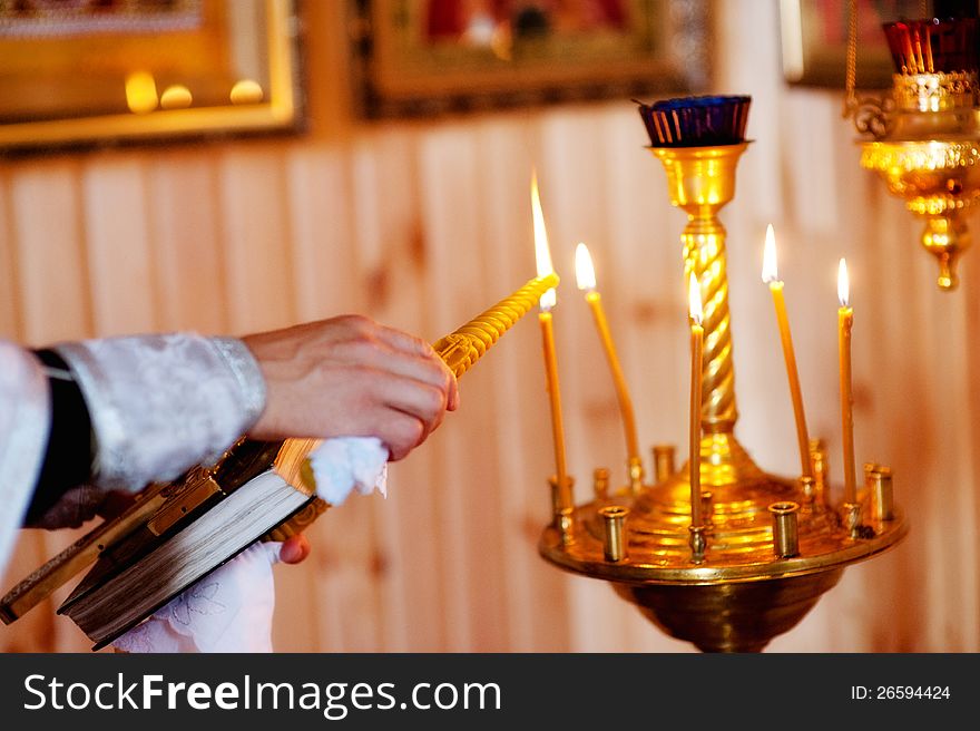 Man hand lighting candles in a church. Man hand lighting candles in a church