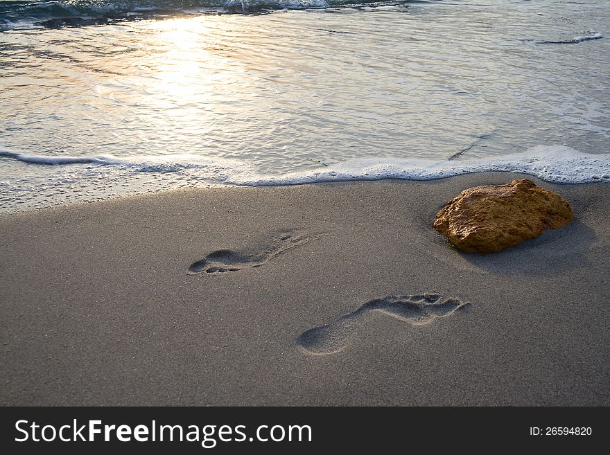 Foot prints on a sandy beach. Foot prints on a sandy beach.