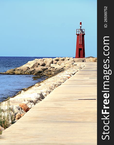 A lighthouse at the end of a marnia in Denia, Alicante Province of spain