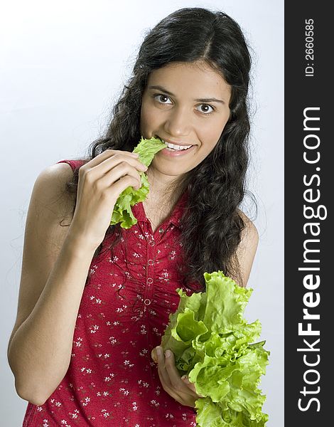 Pretty girl holding fresh lettuce and eating. Pretty girl holding fresh lettuce and eating