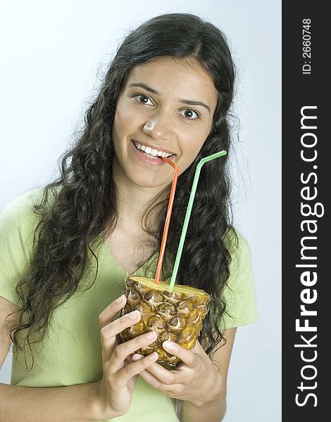 Smiling girl drinking fresh pineapple. Smiling girl drinking fresh pineapple