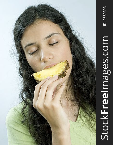 Girl eating pineapple