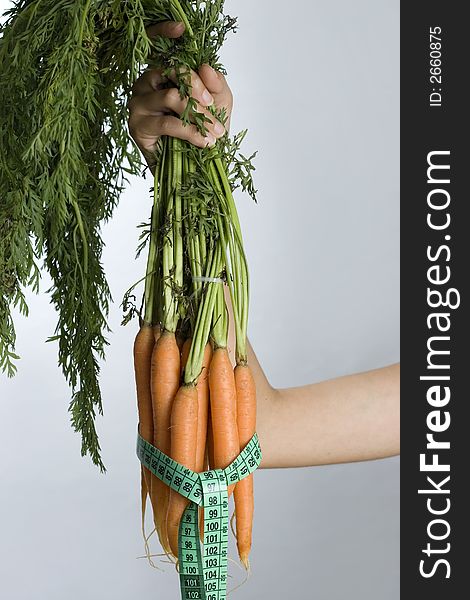 Fresh carrots with measuring tape