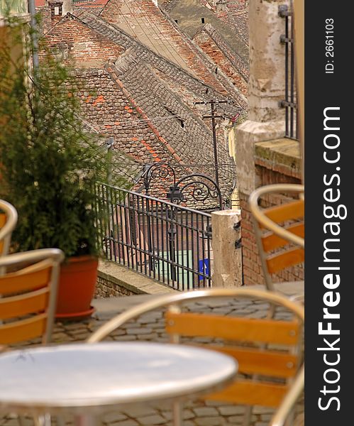 Artistic image of a terrace in a specific German medieval city.Selective focus in the distance on the roofs.The place is located in Sibiu(Hermanstadt),Romania,a city which is during 2007 the European Cultural Capital.This group of images is a great source  of specific Romanian( European) landmarks from a hot place in 2007. Artistic image of a terrace in a specific German medieval city.Selective focus in the distance on the roofs.The place is located in Sibiu(Hermanstadt),Romania,a city which is during 2007 the European Cultural Capital.This group of images is a great source  of specific Romanian( European) landmarks from a hot place in 2007.
