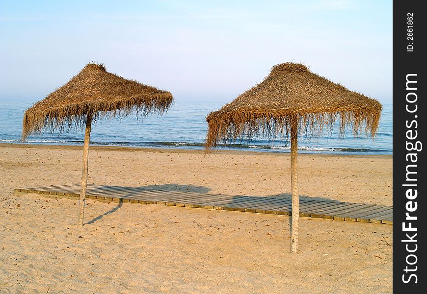 Two classic beach umbrellas by the sea