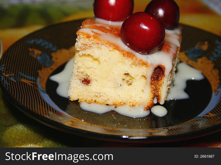 Sweet fruitcake with a cherry and the condensed milk. Sweet fruitcake with a cherry and the condensed milk