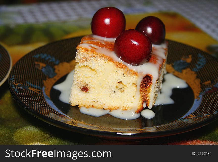 Sweet fruitcake with a cherry and the condensed milk. Sweet fruitcake with a cherry and the condensed milk