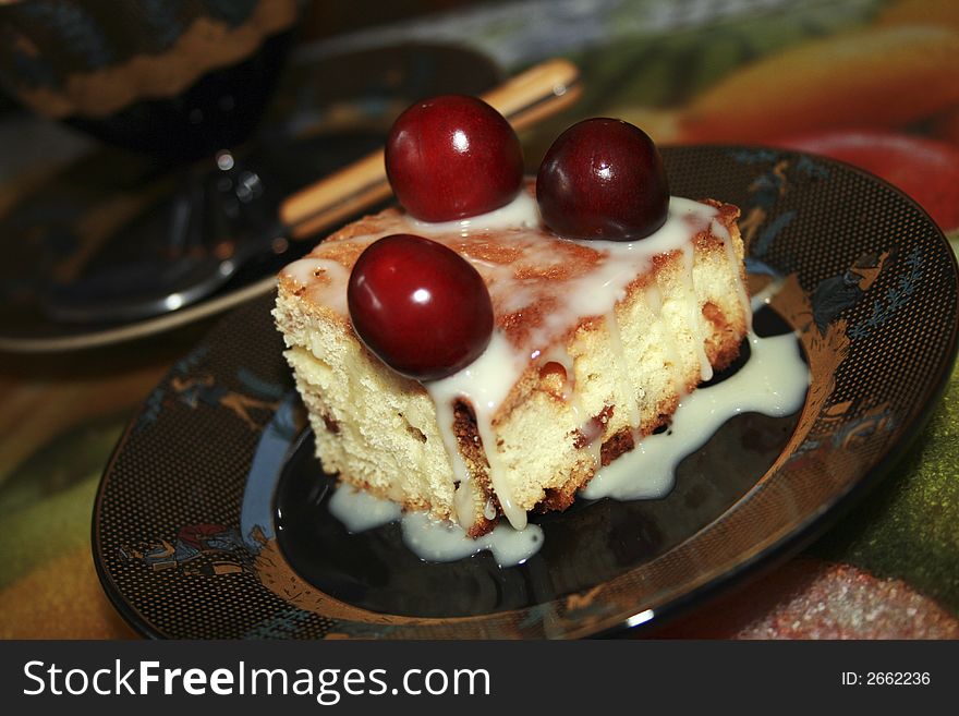 Sweet fruitcake with a cherry and the condensed milk. Sweet fruitcake with a cherry and the condensed milk