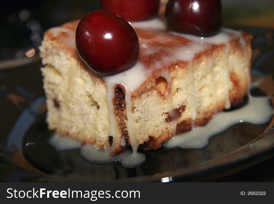 Sweet fruitcake with a cherry and the condensed milk. Sweet fruitcake with a cherry and the condensed milk
