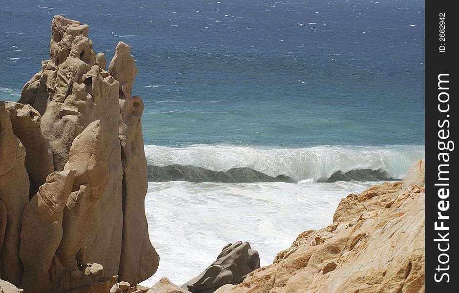 The huge wave just about to break on a rocky Lovers' beach in Cabo San Lucas, Mexico. The huge wave just about to break on a rocky Lovers' beach in Cabo San Lucas, Mexico.