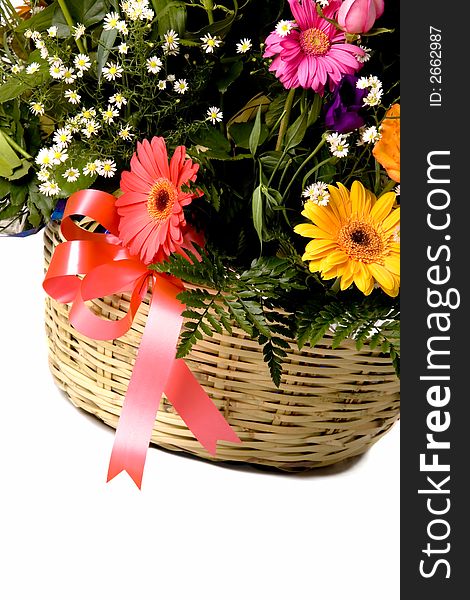 Colorful flowers in brown basket over white. Colorful flowers in brown basket over white