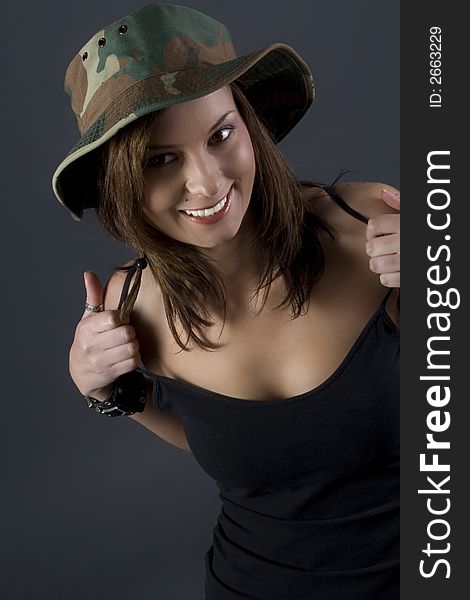 Attractive brunette military girl with a camouflage hat and black shirt. Attractive brunette military girl with a camouflage hat and black shirt