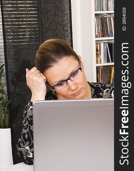 Young woman in eyeglasses in front of the laptop computer. Young woman in eyeglasses in front of the laptop computer