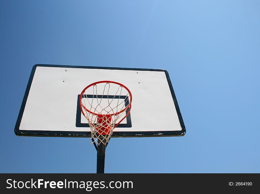 Basketball hoop, street basketball under clear blue sky. Basketball hoop, street basketball under clear blue sky