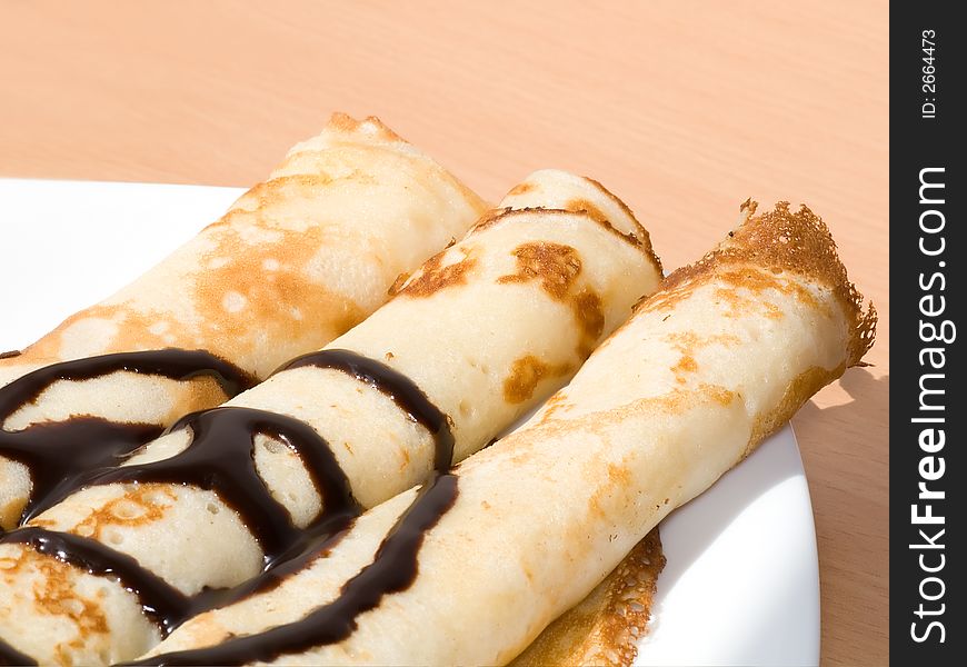 Three twisted pancakes with chocolate. Three twisted pancakes with chocolate