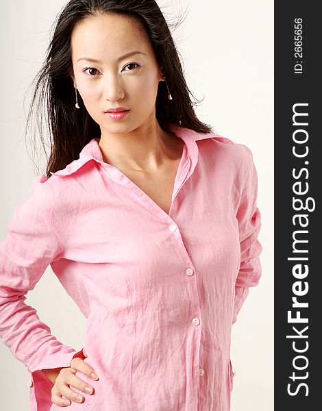 Enticing Chinese girl with flying hair in pink shirt