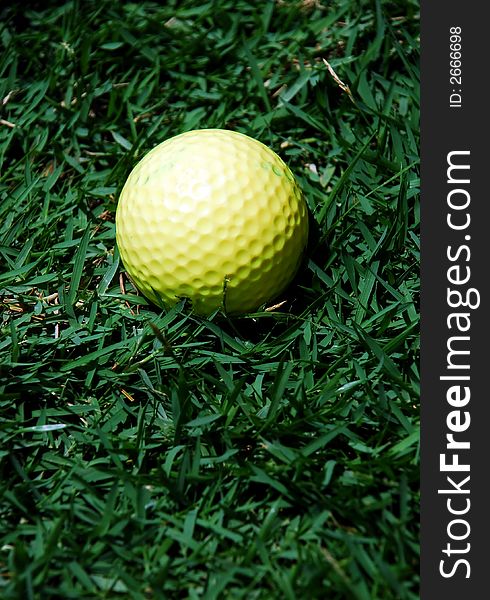 Yellow golf ball image on the green grass background