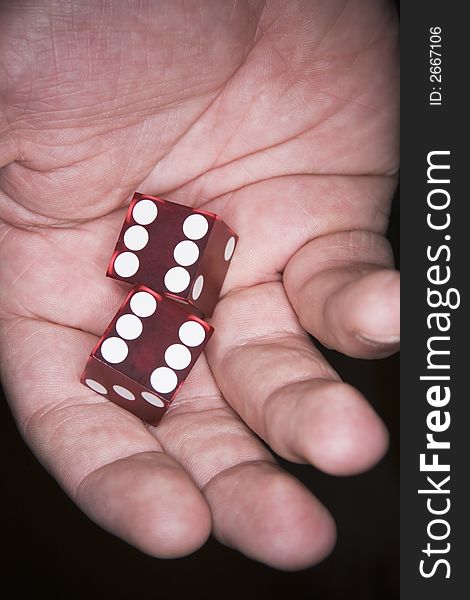 A Man's hand holding lucky poker dice. A Man's hand holding lucky poker dice