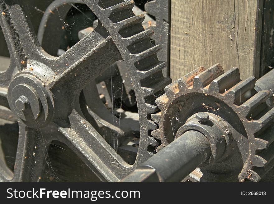 Old cogwheels covered with web.