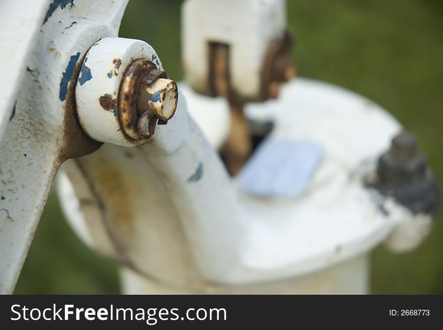 Detail of old white water pump with the blue soap.