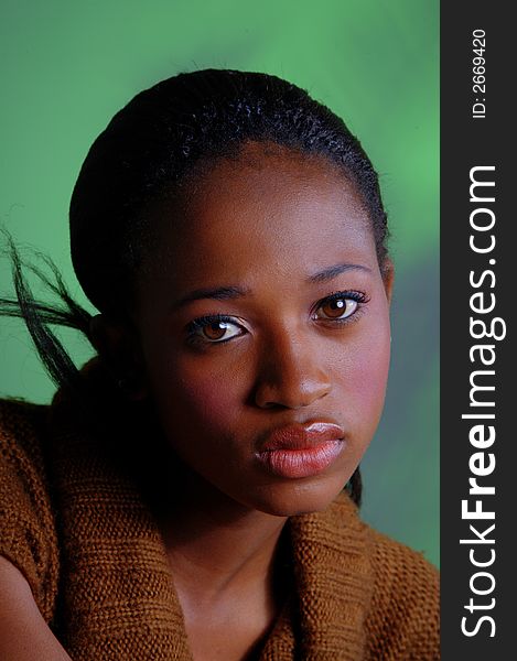 African lady with beautiful brown eyes in front of a diffused background. African lady with beautiful brown eyes in front of a diffused background.