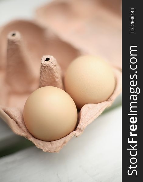 Two Organic freerange eggs in egg box