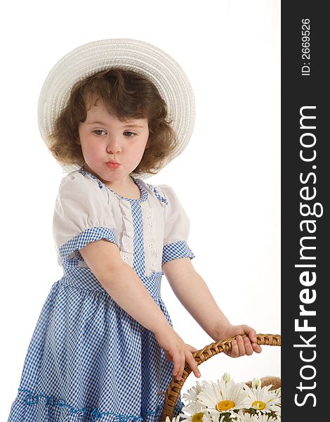 A little beautiful girl with bonnet, with a basket with flowers and toys. A little beautiful girl with bonnet, with a basket with flowers and toys.