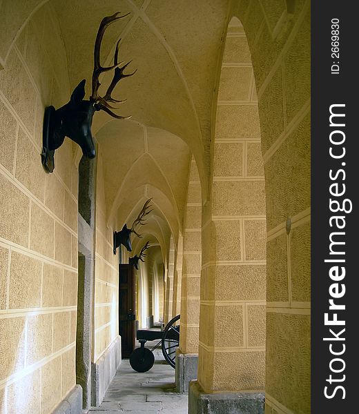 Gothic castle courtyard with canon, deer heads and lancets. Gothic castle courtyard with canon, deer heads and lancets