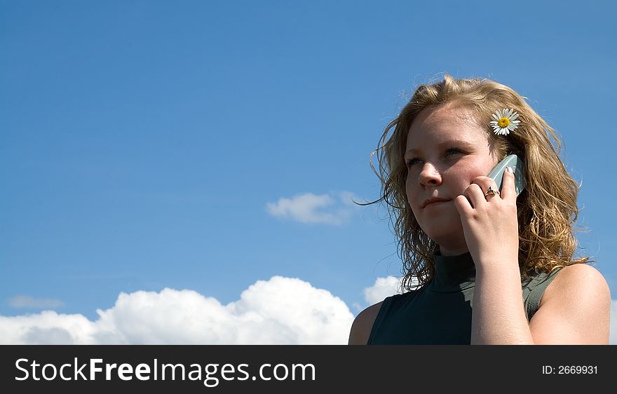 Girl talking on the phone on a sunny day