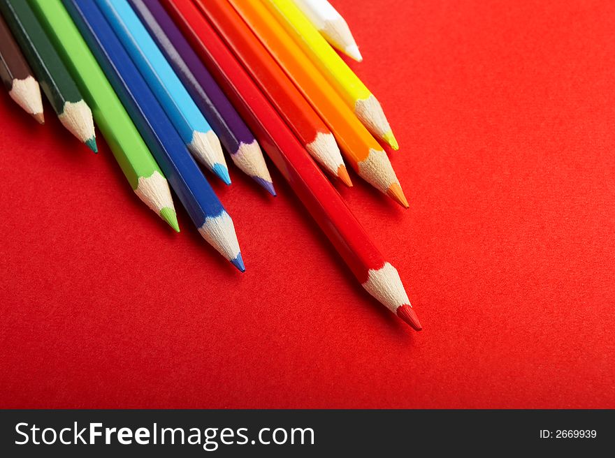 A Stack of Colored Pencils on Red Background - check my gallery for more pictures. A Stack of Colored Pencils on Red Background - check my gallery for more pictures