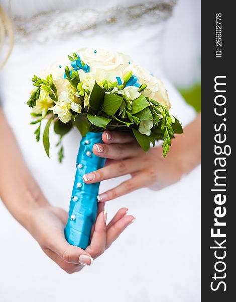 Wedding bouquet on bride closeup