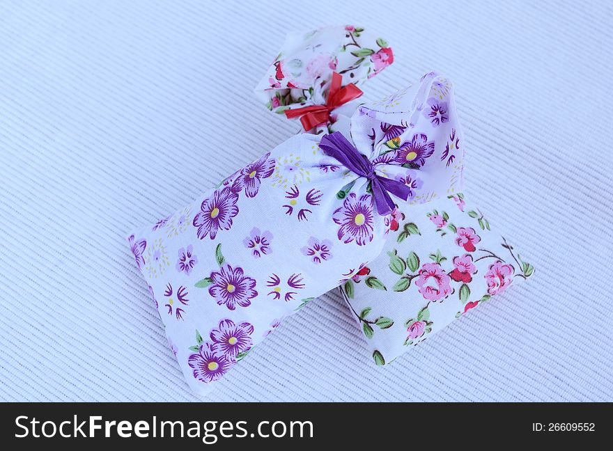 Two flower aroma bags on light background