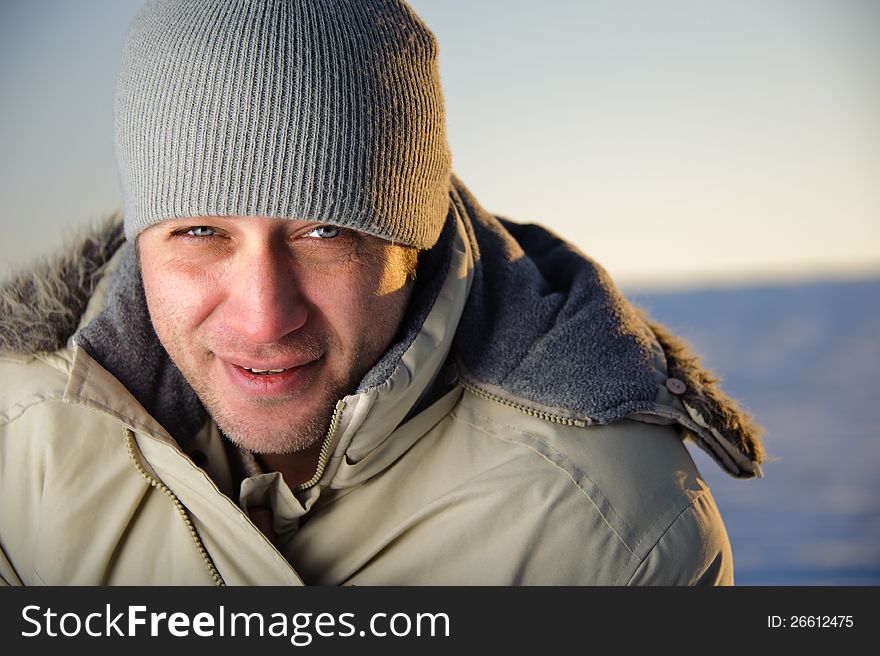 Portrait of man in warm gray jacket and hat. Closeup. Portrait of man in warm gray jacket and hat. Closeup.