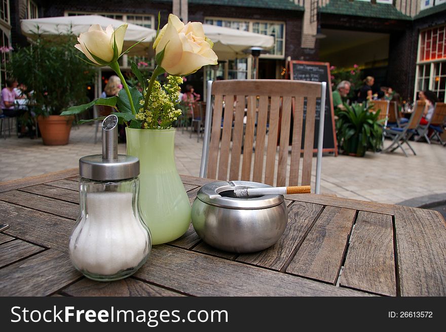 Table of bar with vase of flowers, ashtray and sugar bowl  outdoor;. Table of bar with vase of flowers, ashtray and sugar bowl  outdoor;