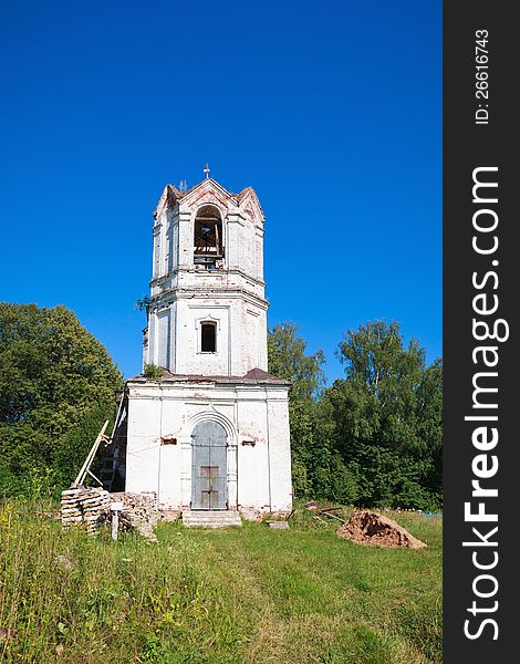 Old orthodox church against the clear blue sky and greenery.