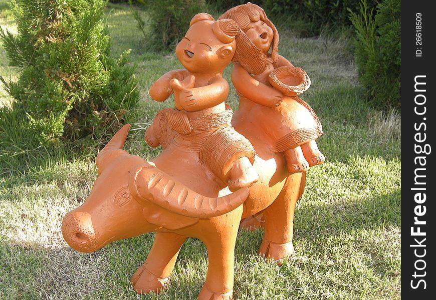 Children riding buffalo statue.