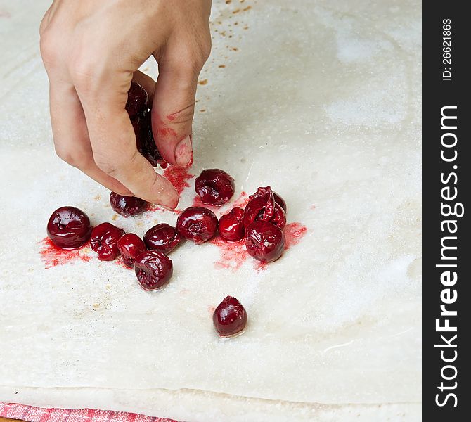 Female Hands Making Small Pies With Cherry