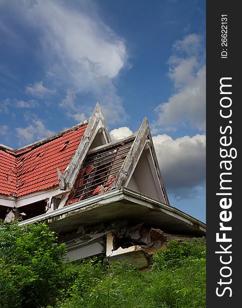 Ruins of the thai house has red roof broken down which is located clouds and sky. Ruins of the thai house has red roof broken down which is located clouds and sky.