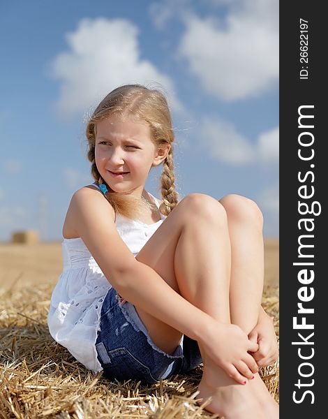 Blond girl on a haystack clean air