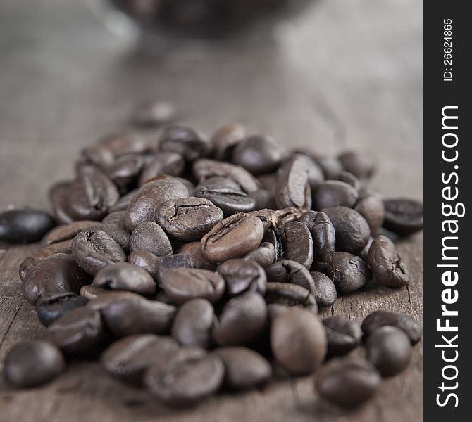 Close up of coffee beans on old wooden able