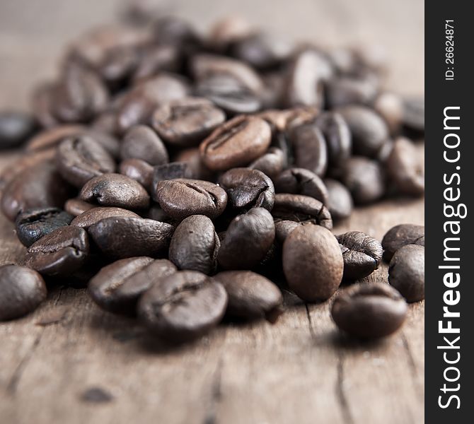 Close up of coffee beans on old wooden able